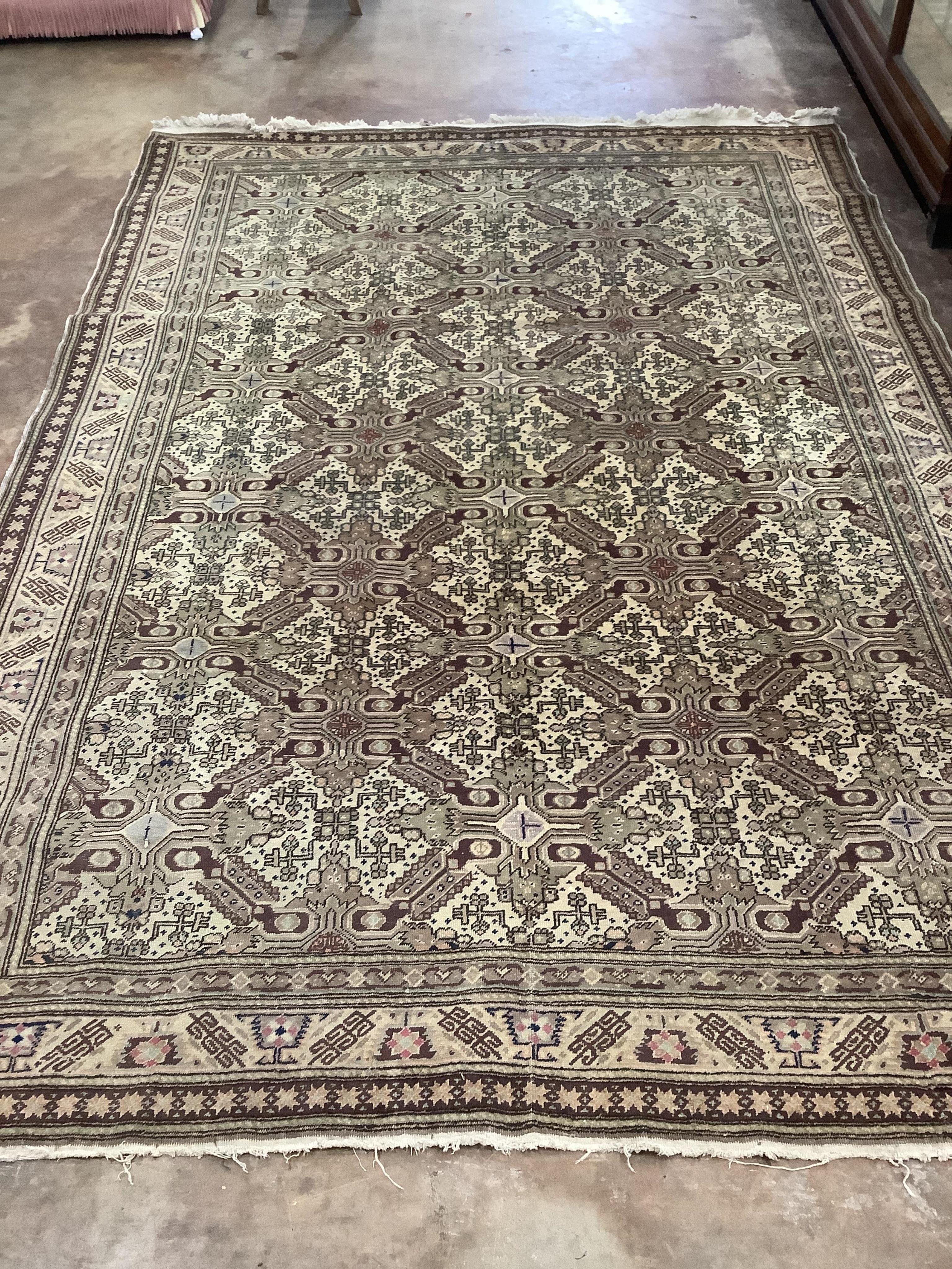 An ivory ground geometric carpet, approx. 290 x 200cm. Condition - fair